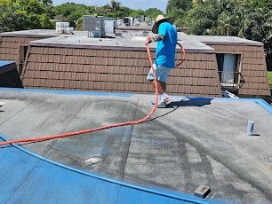 Expert Roofing crew applying silicone roof coating in Florida
