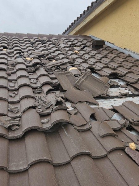 Storm damage to a Florida roof documented by Expert Roofing Services